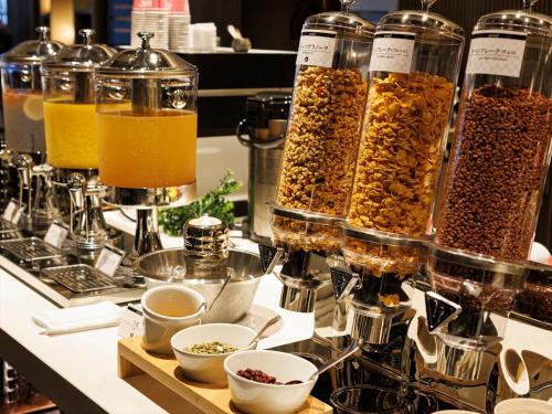 a counter with many glass jars filled with different types of food at THE BLOSSOM KYOTO in Kyoto