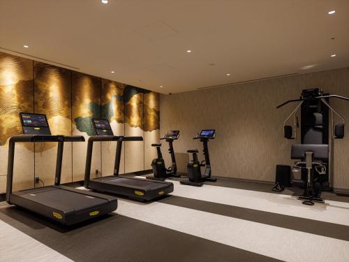 a fitness room with cardio machines and a treadmill at THE BLOSSOM KYOTO in Kyoto