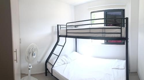 1 dormitorio con 2 literas y ventilador en Apartamento Portal de la Sierra 3 Habitaciones, en Santa Marta