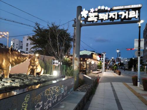 a statue of a cow on the side of a street at Jeju Vision House in Jeju