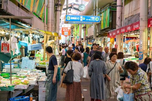 a group of people walking around a market in a street at Close to you in Kanazawa