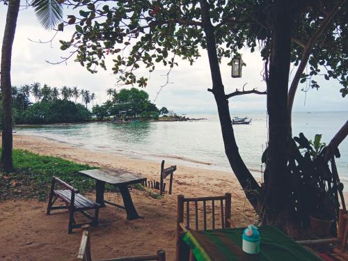a picnic table and bench on the beach at Breizh Cape Beach Bungalows in Ko Lanta