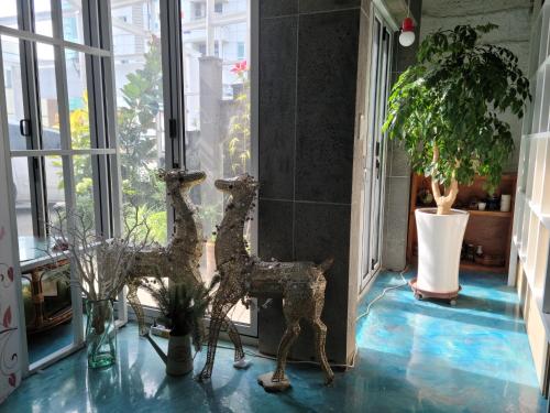 a statue of a giraffe standing in a hallway at Jeju Vision House in Jeju