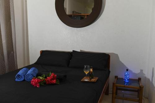 a bed with two glasses of wine and flowers on it at The balcony of the camiguin island in Mambajao