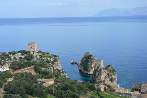 an island in the water with a castle on it at Villa delle Stelle in Scopello