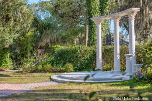 a gazebo in the middle of a garden at Sweetwater Branch Inn in Gainesville