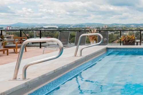 a swimming pool on the roof of a building at CONDO MID-CENTURY MODERN STYLE - POOL/TERRACE in Quebec City