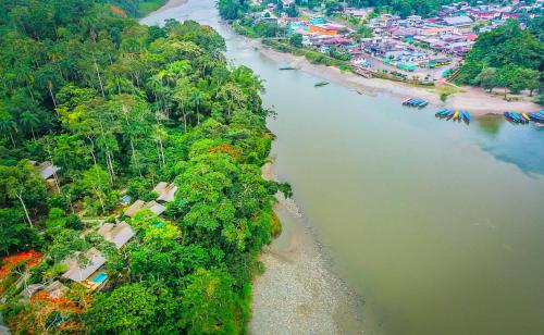 an aerial view of a river with trees and a beach at El Jardin Lodge & Spa in Puerto Misahuallí