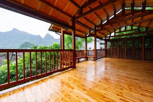 an empty deck with a view of the mountains at Yangshuo Secret Garden in Yangshuo