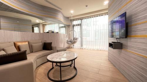 a living room with a couch and a table at Twelve Constellation Garden Resort in Hengchun