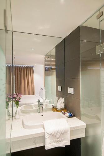a bathroom with a sink and a mirror at Soho Boutique Hotel in Danang