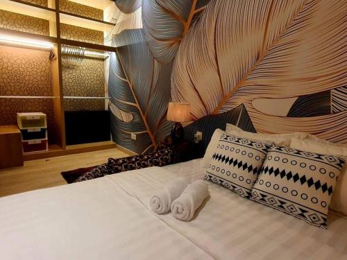 a bedroom with a bed with two towels on it at Executive Premium Comfy Home Mount Austin JB 5Pax in Johor Bahru