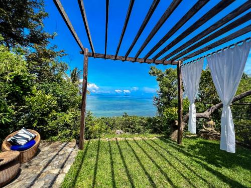 a pergola with a view of the ocean at The Dream Beach Resort in Taytay