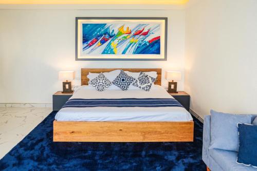 a bedroom with a bed with pillows and a painting at The Dream Beach Resort in Taytay