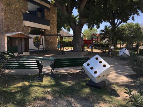 a park with a bench and a playground at Apartamento Santa Marta Piscina cerca del Rodadero in Santa Marta