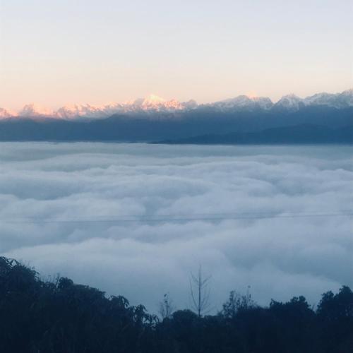 a view of a sea of clouds with mountains in the background at Sunrise Point Homestay in Nagarkot