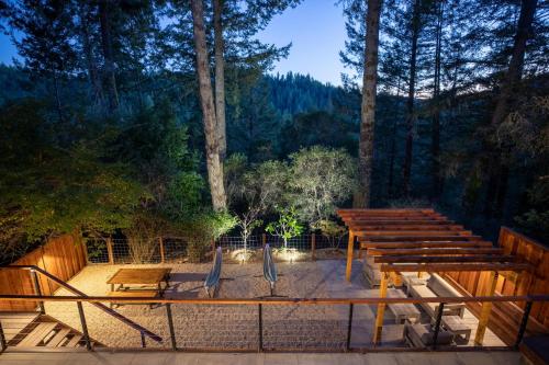 a deck with benches and a playground with trees at Valley Vista A Wine Country Escape in Guerneville