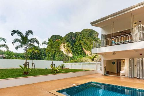 an exterior view of a house with a swimming pool at 8 Palm Villa - Private Pool Villas in Aonang in Ao Nang Beach