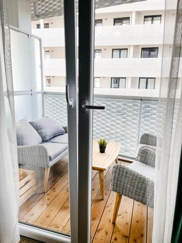 a balcony with a couch and a table and a building at Apartamenty City Tower od WroclawApartament-pl in Wrocław