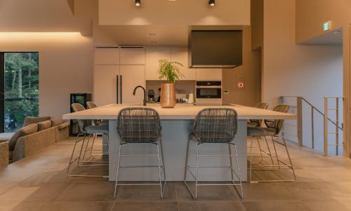 a kitchen with a large island with bar stools at hotel norm air in Fujikawaguchiko