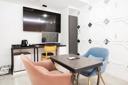 a living room with a table and chairs at Ytt Hotel in Busan