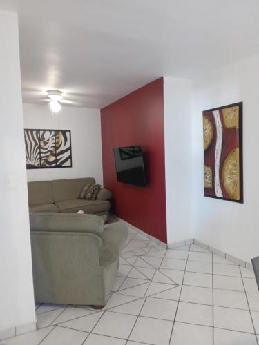 a living room with a couch and a red wall at Casa 12-1 - Beautiful Mountain Views (Newly Renovated - Pictures To Come!) in San Carlos