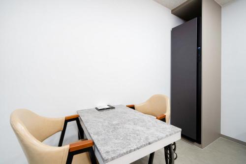 a dining room with a table and chairs at Ytt Hotel in Busan