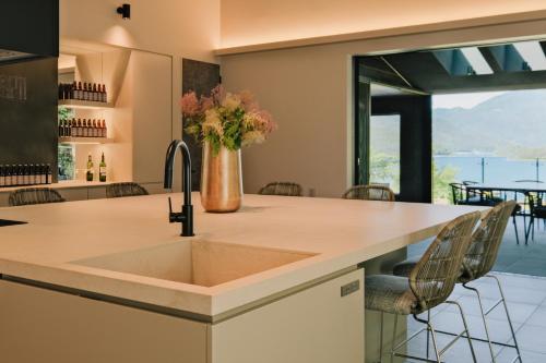 a kitchen with a sink and a large window at hotel norm air in Fujikawaguchiko