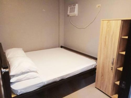 a small room with a bed and a closet at Minimalist 2 bedroom house in Opol