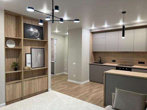 a kitchen with white cabinets and a counter top at Freedom elite apartment in Astana