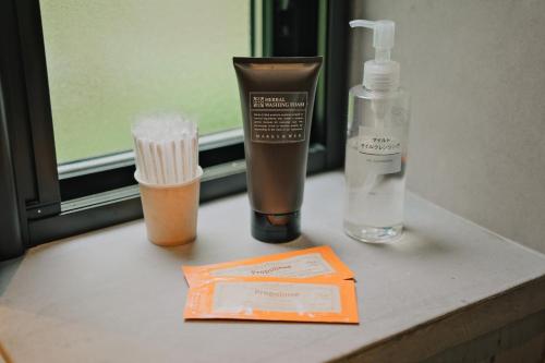 a bathroom counter with a bottle of lotion and a toothbrush at hotel norm. fuji in Fujikawaguchiko