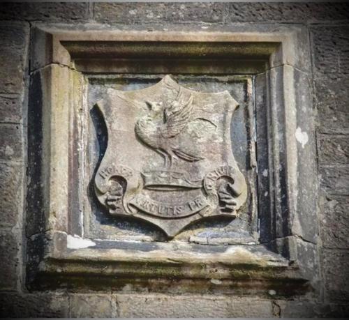 a crest on the side of a building at Lomond Castle Penthouse in Luss