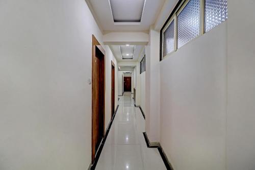 a hallway of a building with white walls and a ceiling at Sun Inn Residency Rabale in Navi Mumbai
