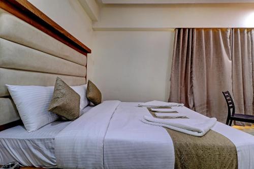 a hotel room with a bed with towels on it at Sun Inn Residency Rabale in Navi Mumbai