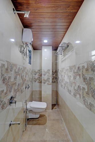 a bathroom with a toilet and a sink in it at Sun Inn Residency Rabale in Navi Mumbai