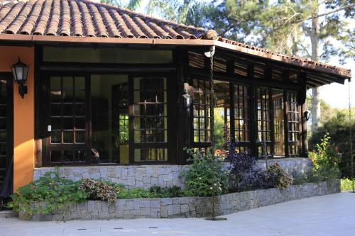 a screened in porch of a house at Auberge Suisse Pousada in Nova Friburgo