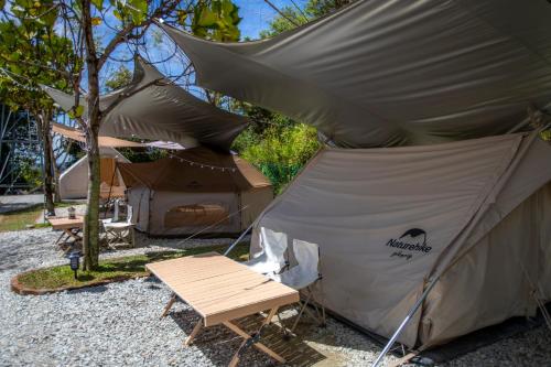 a tent with a table and a chair in front of it at Stellar GoldenHill Cameron in Tanah Rata