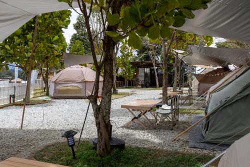a campground with a tent and a picnic table at Stellar GoldenHill Cameron in Tanah Rata