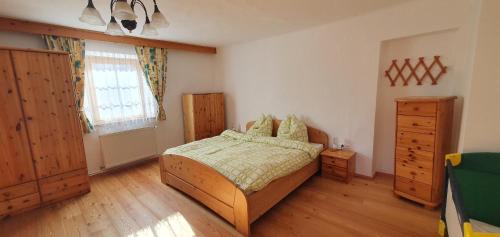 a bedroom with a bed and a dresser and a window at Haus Stoffenhof in Rosenberg