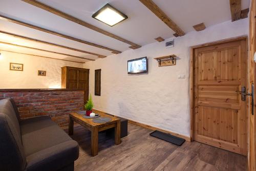 a living room with a couch and a door at ARAMIKA apartamenty in Szklarska Poręba