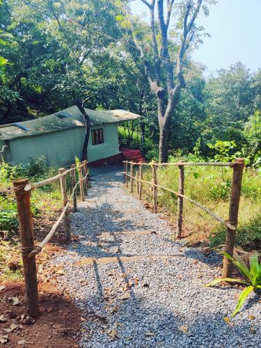 a path leading to a small house with a fence at Samyama Retreat in Cola