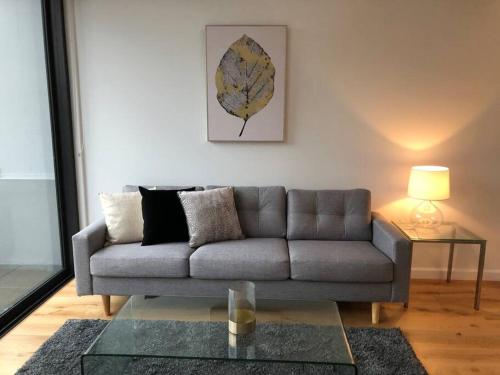 a living room with a couch and a table at Beautiful Apartment in Chatswood in Sydney