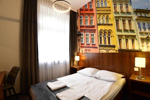 a bedroom with a bed in front of a building at Hotel Downtown Kraków in Krakow