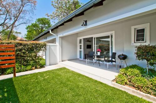 a home with a patio and grass yard at Kent Manor Guest Suites in Johannesburg