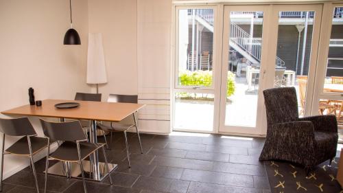 a dining room with a table and chairs at Hotel Strandtangen in Skive