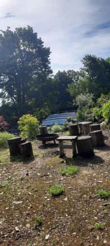 a picnic table and benches in a field at Relax pension Schonwald in Budišov nad Budišovkou
