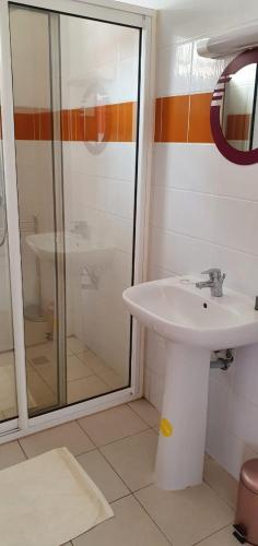 a bathroom with a sink and a glass shower at Mana 45 B in Mana