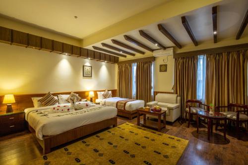 a hotel room with a bed and a living room at Siddhartha Boutique Hotel, Boudha in Kathmandu