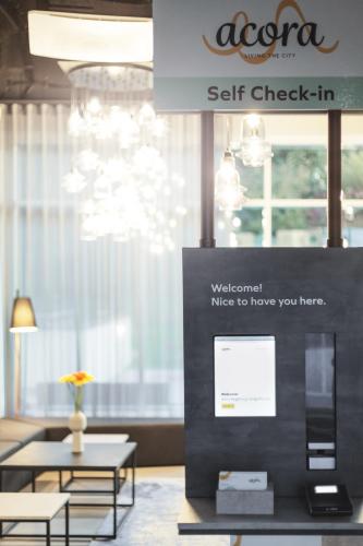 a sign in a room with a table and chairs at Candlewood Suites Augsburg in Augsburg