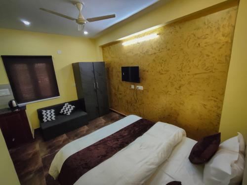 a bedroom with a bed and a couch in it at Skylight homestay in Dehradun